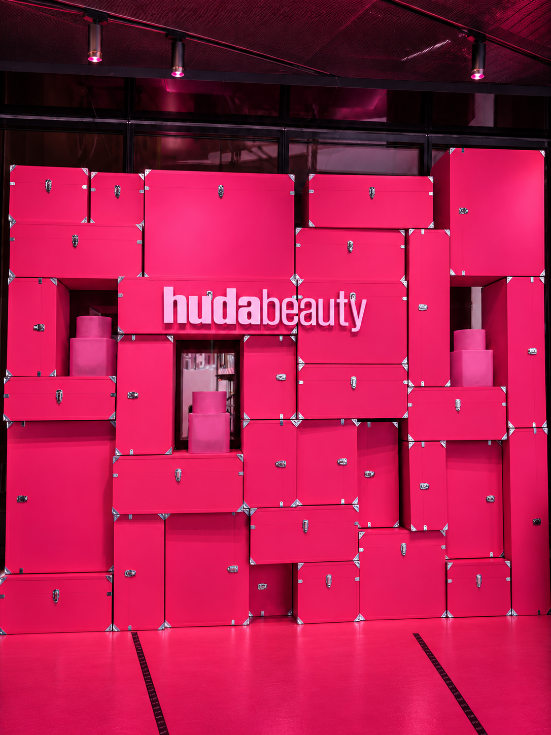 Huda Beauty experiential installation built from vivid pink flight cases